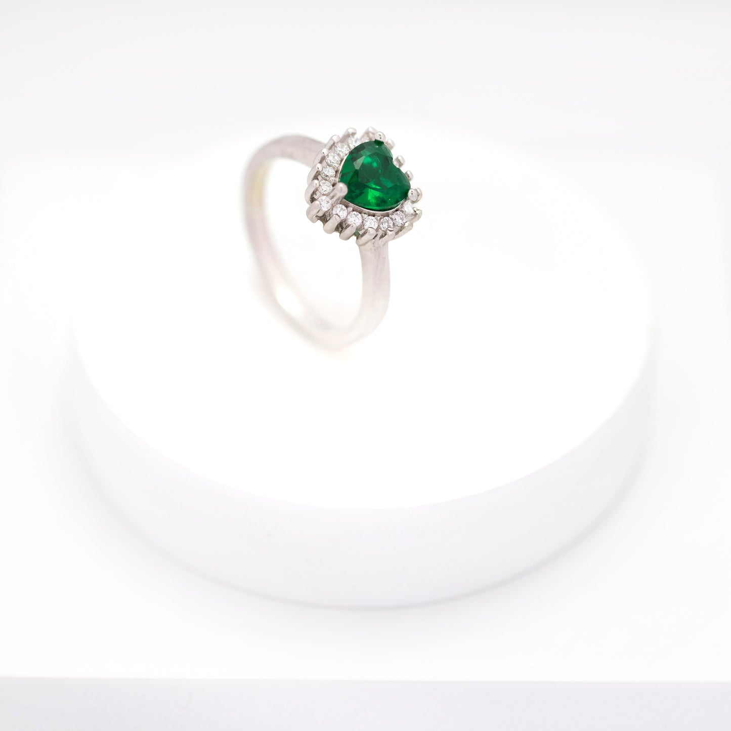 top view of elegant emerald heart cluster diamond ring