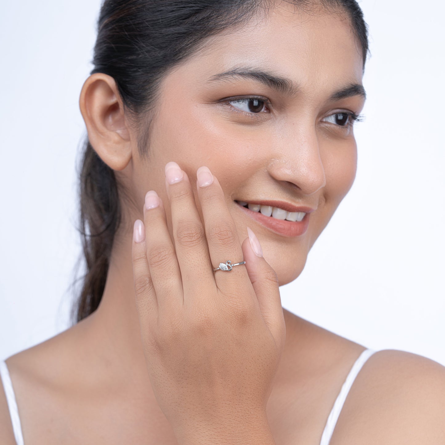 Silver swan ring with stone detailing on a model's hand