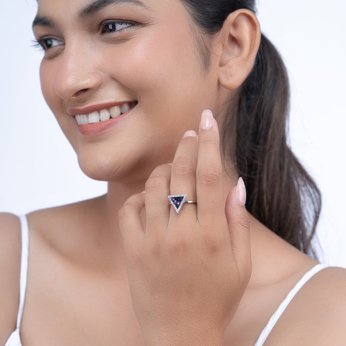 Violet Prism design handcrafted sterling silver ring with trillion cut amethyst on a model's hand