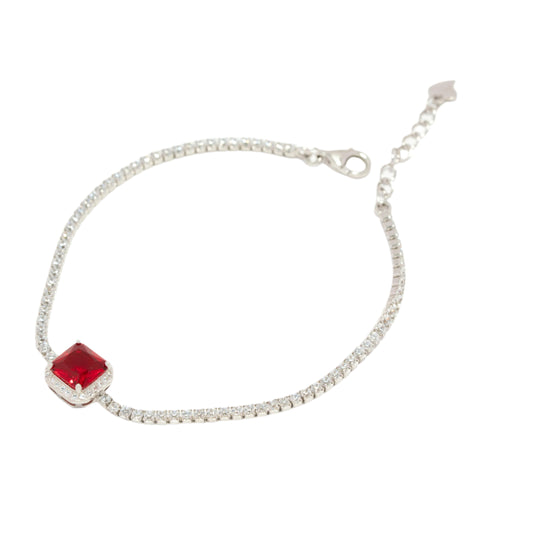 Silver bracelet with a red gemstone on a white background