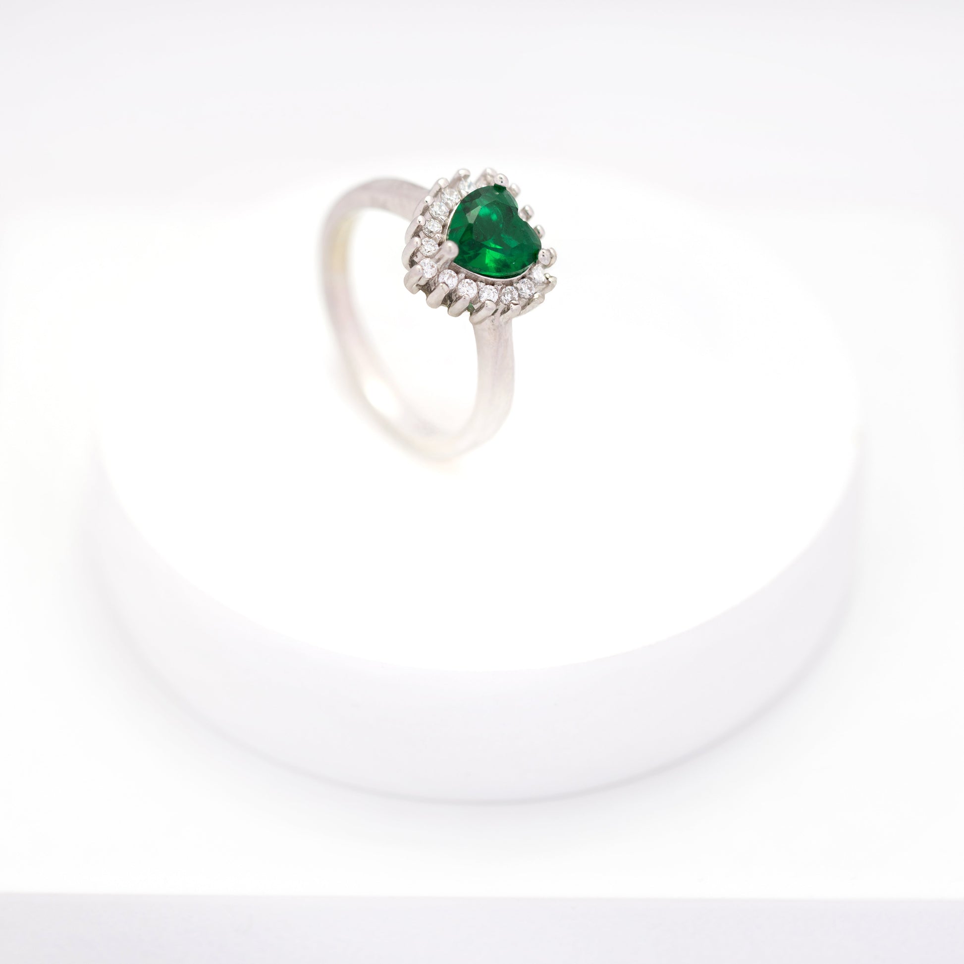 top view of elegant emerald heart cluster diamond ring 