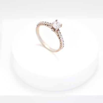 Elegant silver ring for women with a sleek, minimalist design, displayed on a white pedestal