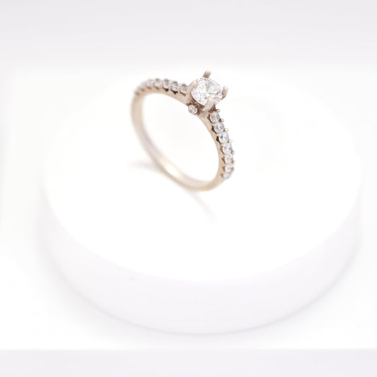 Elegant silver ring for women with a sleek, minimalist design, displayed on a white pedestal