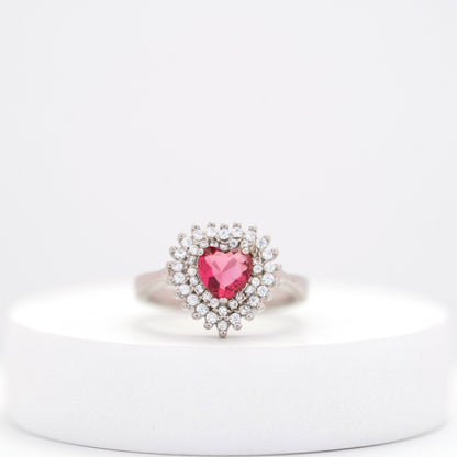 front view of dainty silver ring featuring a pink heart gem and brilliant diamond halo. 