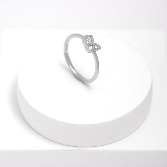 Silver swan ring on a white stand